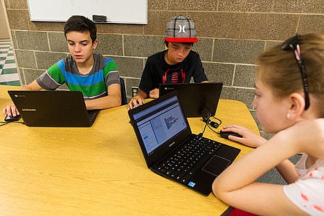 &lt;p&gt;Vaugh Bassaillion, left, and Noah Martinez participate in code programming in their Zero Robotics class.&lt;/p&gt;