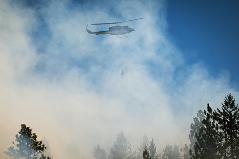 &lt;p&gt;A firefighter repels from a helicopter to assist in the efforts.&lt;/p&gt;