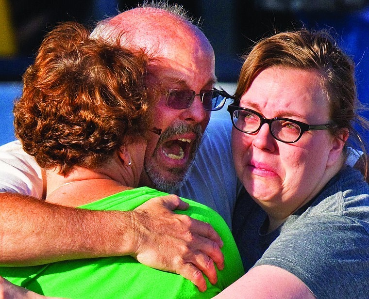 &lt;p&gt;Tom Sullivan, center, embraces family members outside Gateway High School where he was searching frantically for his son, Alex Sullivan, who celebrated his 27th birthday by going to see &#147;The Dark Knight Rises&#148; at the Aurora, Colo., theater where a gunman opened fire Friday.&lt;/p&gt;