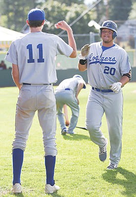 &lt;p&gt;Kylie Richter/ Lake County Leader Erik Lauer, left, gives Trace Tammaro, right, a high five after Tammaro scored a run in the Loggers' game against the Bitterroot Bucs on Thursday in Polson.&lt;/p&gt;