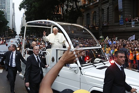 &lt;p&gt;Security guards scan the crowds cheering as Pope Francis rides in his popemobile in Rio de Janeiro, Brazil, Monday. The pontiff arrived for a seven-day visit in Brazil, the world's most populous Roman Catholic nation. During his visit, Francis will meet with legions of young Roman Catholics converging on Rio for the church's World Youth Day festival.&lt;/p&gt;