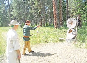 &lt;p&gt;&#147;Two-Knives&#148; throws a tomahawk and knives at logs set up near the Rendezvous campground. Dean Thompson waits for his turn, fresh off shooting his flintlock pistol.&lt;/p&gt;