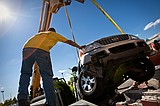 SUV bulls over cinderblock wall at Hayden hotel