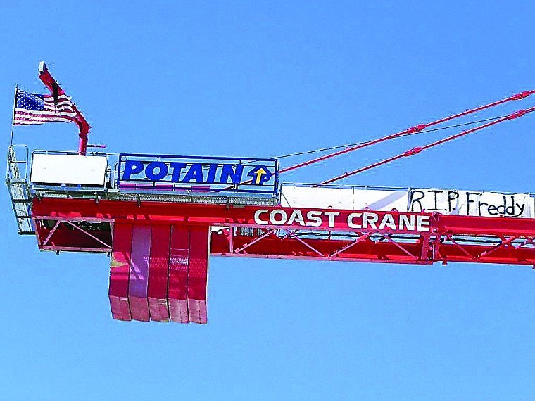 <p>The “R.I.P. Freddy” banner placed atop the tower crane in Kalispell is in memory of union crane operator Fred Winston.</p>
