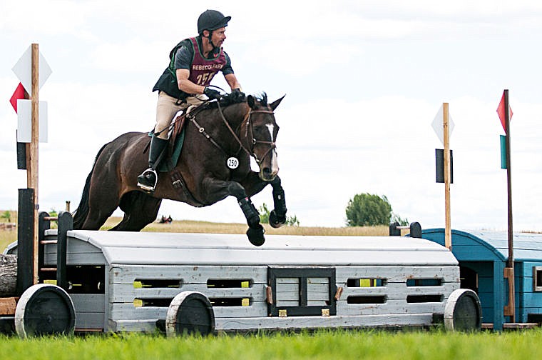 <p>Kalispell’s Braun Lowry and Annamation clear the final jump during the Senior Open Training cross-country event Friday afternoon at The Event at Rebecca Farm. </p>