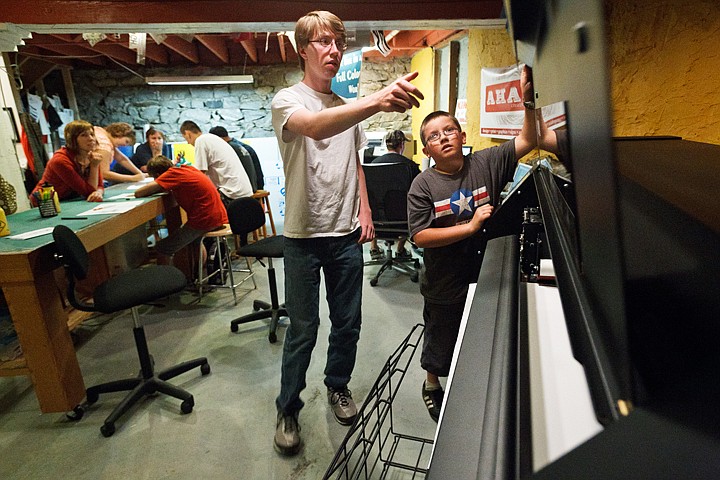 &lt;p&gt;SHAWN GUST/Press Chris Jenkins, 12, and Richard Peterson, 17, close the lid to a thermal printer while printing custom stickers Friday at AHA! Creative during a design workshop for Project Safe Place clients. Art on the Edge joined the two non-profits in hosting the one-day workshop allowing a half dozen youth a creative outlet.&lt;/p&gt;