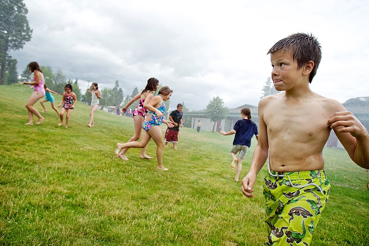 &lt;p&gt;JEROME A. POLLOS/Press Austin King keeps an eye out for frantic classmates running through the downpour created by a Coeur d'Alene Fire Department fire engine Thursday during a last day celebration for CDA4Kids at Fernan Elementary.&lt;/p&gt;