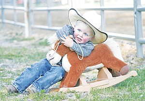 <p>Rodeo kiddo Slade Stubblefield, 2, tackles "Danger" for a winning time in the horse wrestling event  the Kootenai River Rodeo. Slade is the son of Nick Stubblefield, steer wrestler from Choteau - another Montana family who have strong ties to rodeo.</p>