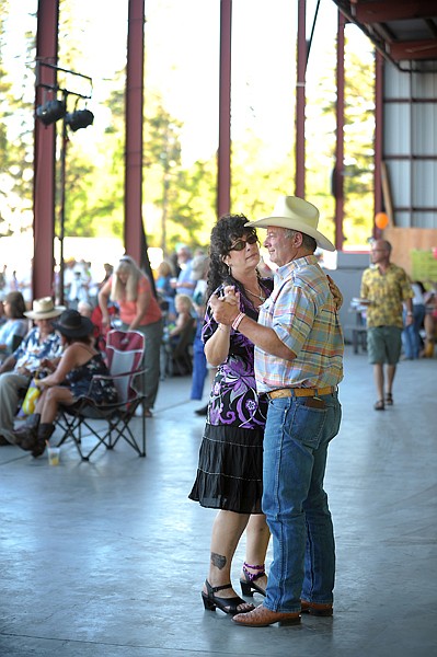 <p>From left, Storm Yetter dances with Jerry Tinkess, both of Kalispell, on Saturday, July 21, at the Somers Cajun Street Dance.</p>