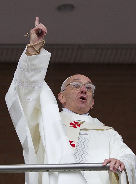 &lt;p&gt;Pope Francis comments on the rain to pilgrims as he stands on a balcony at the Aparecida Basilica after celebrating Mass in Aparecida, Brazil, Wednesday. Tens of thousands of faithful flocked to the tiny town of Aparecida, tucked into an agricultural region halfway between Rio de Janeiro and Sao Paulo, where he is to celebrate the first public Mass of his trip in a massive basilica dedicated to the nation's patron saint.&lt;/p&gt;