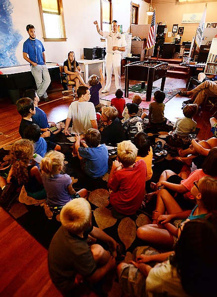 <p>Master Chief Petty Officer Robert Stout talks with children from the Boys and Girls Club on Wednesday afternoon, July 25, in Columbia Falls. (Brenda Ahearn/Daily Inter Lake)</p>