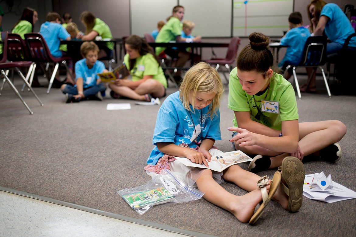 &lt;p&gt;Maddie Hyland, 7, reads to Lauren Baldeck, 12, at the third-annual KIDS Camp on Monday at Fernan Elementary. The Camp offers elementary school students the opportunity to hone their reading, math and music skills during the summer months.&lt;/p&gt;