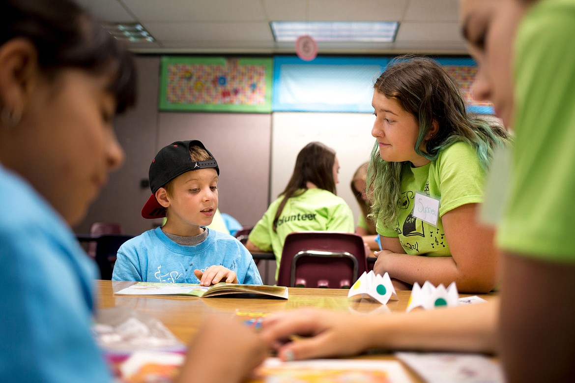 &lt;p&gt;Micah Matlock, 8, reads out-loud to Sydney Larsen, 14, at the KIDS Camp on Monday at Fernan Elementary School. In addition to group activities, elementary school students receive one-on-one attention from middle and high school students and adult volunteers.&lt;/p&gt;