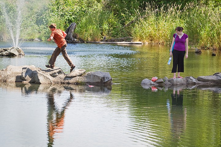 &lt;p&gt;Cody Carson leaps across a rocky bridge Tuesday as Christina Robinson looks on during an outing to Falls Park in Post Falls.&lt;/p&gt;