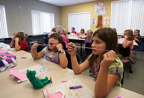 &lt;p&gt;Madison Whaley, 9, right, and Kaitlyn Miller, 6, learn the benefits of flossing their teeth during Health club on Wednesday morning at the Kootenai County Boys and Girls club. &#160;&lt;/p&gt;