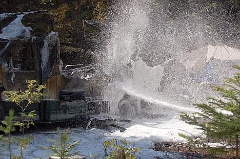 &#151;Photo by ELAINE SANDMAN&lt;br&gt;Hall Mountain Volunteer Firefighters foam an RV Motor coach parked at the Copper Creek campgrounds near Eastport. The fire completely gutted the motor home at around 1 p.m. on July 18.