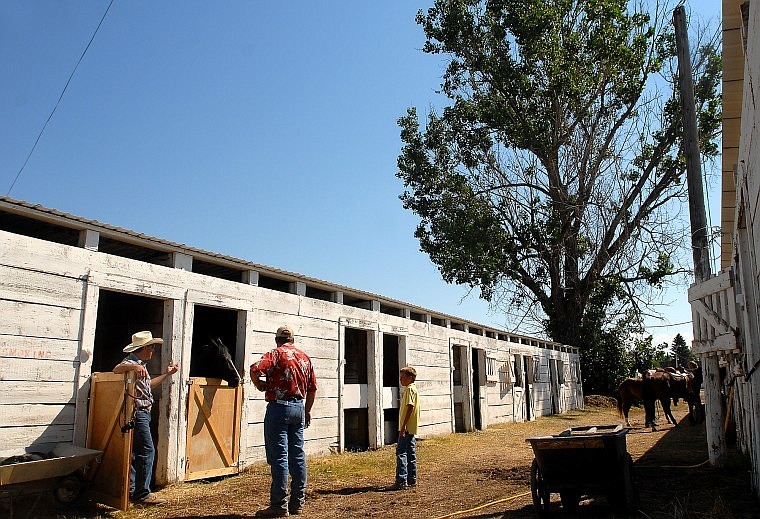 Tony Penna talks with Shawn and Cooper Kohr in the stable area.