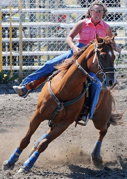 Tonya Kohr turns her horse Shiloh around after making a turn around a pole.