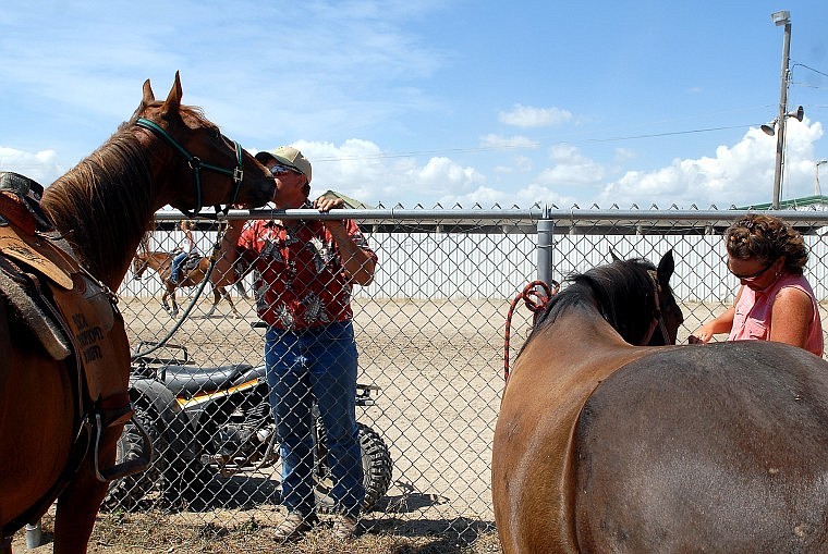 Shawn Kohr gives a kiss while Tonya gives treats to the family's horses.