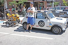 Xavier Morigeau poses in front of his dream car during the Mariners road trip down to Hamilton.