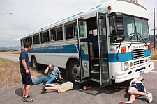 Team members try to fix the Mariners' bus after it broke down.