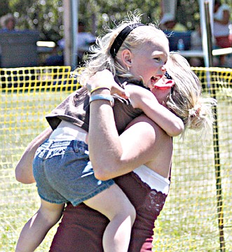 &lt;p&gt;After completing a foot race in the ages five-and-under division, Addyson Lewis is lifted into the arms of her mother, Meghan Lewis.&lt;/p&gt;