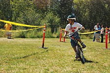 Sage Chiefstick, of Ronan, rounds a corner during the BMX bike race. He took first place and won a brand new orange bike.