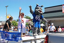 Margene Asay and the Mission High School mascot wave to the crowd during the Good Old Days parade.