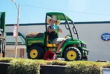 Garrett O'Connor, 5, of Arlee, sits on the Pro-Sod Farm float.