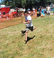 Israel Umphrey runs alongside his seven-month-old dog Mea during the dog race.