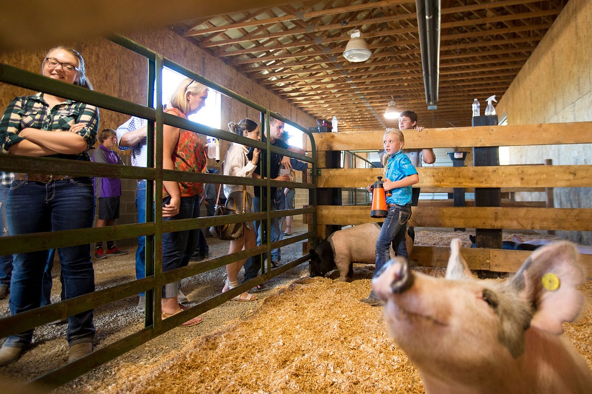 &lt;p&gt;Pheiffer Rosenberger, 8, showcases pigs she raised and cares for while at the Rocking R Ranch's third-annual 4H fundraising event in Hayden.&lt;/p&gt;