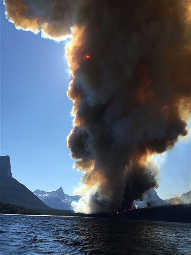 &lt;p&gt;In this photo taken Tuesday, July 21, 2015, smoke from the Reynolds Creek Fire rises above the landscape at St. Mary Lake in Glacier National Park. State Rep. Jenny Eck, who was hosting a delegation from Australia on a tour of the park, took this photo of the fast-moving wildfire. The flames torched a car and a historic cabin and forced tourists to abandon their vehicles on the park's most popular roadway while officials evacuated hotels, campgrounds and homes. (Jenny Eck via AP)&lt;/p&gt;