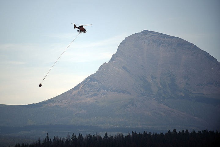 &lt;p&gt;A crew from Flathead Helitack prepares to land in East Glacier on Wednesday, July 22. Smoke from the Reynolds Creek Fire which has grown to 4,000 acres, was beginning to come through the mountains into the St. Mary area. (Brenda Ahearn/Daily Inter Lake)&lt;/p&gt;