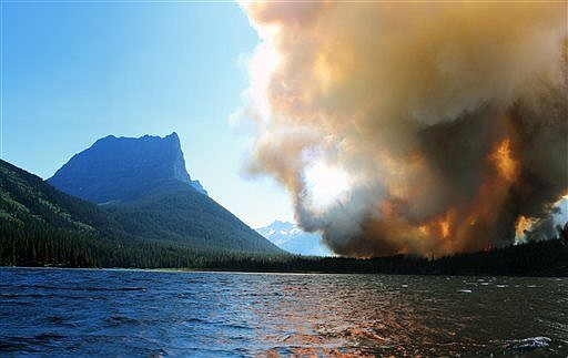 &lt;p&gt;In this photo provided by Erin Conwell taken Tuesday, July 21, 2015, smoke from the Reynolds Creek wildfire rises above St. Mary Lake in Glacier National Park. The fire burning in the drought-parched northwestern Montana park doubled in size Wednesday, leading officials to evacuate homes along St. Mary Lake and visitors to flee hotels and campgrounds in the nearby community at Glacier&#146;s eastern entrance. (Erin Conwell via AP)&lt;/p&gt;