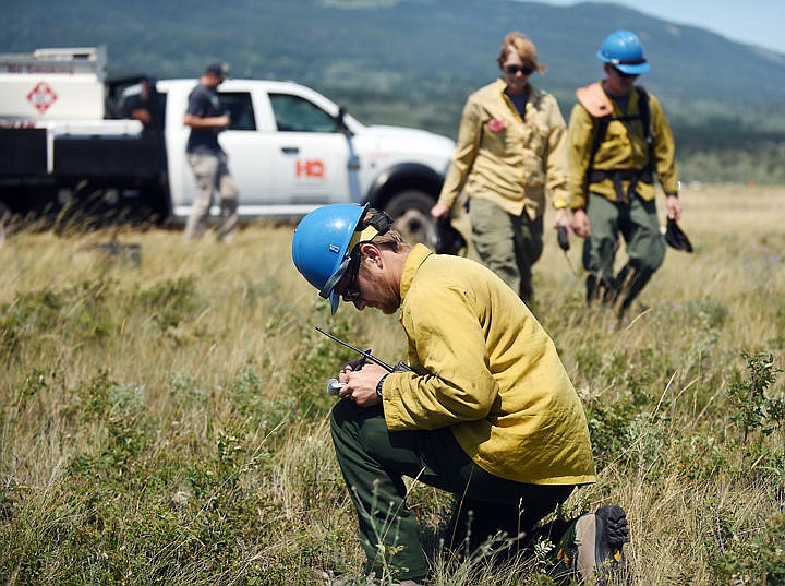 &lt;p&gt;Joel Anderson of Flathead Helitack making notes after the crew takes off for a flight over the Reynolds Creek Fire on Wednesday, July 22, in East Glacier. (Brenda Ahearn/Daily Inter Lake)&lt;/p&gt;
