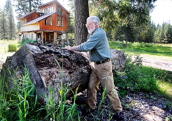 &lt;p&gt;Lee Secrest removes bark from a log at his home north of
Polebridge on Thursday. In the background is Secrest&#146;s studio that
he describes as &#147;hippie house&#148; style &#151; something that has been
added to over the years.&lt;/p&gt;