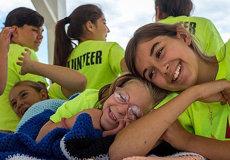 &lt;p&gt;Katy Ryan (12), left and Lea Hyshop (9), lay together while waiting for members of the Coeur d'Alene Aero-Modeling Society to fly their remote control planes on Tuesday afternoon.&lt;/p&gt;