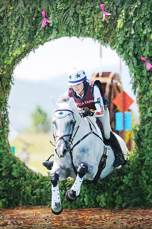 <p>Kristi Nunnink of Auburn, Calif., rides R-Star through the keyhole jump on the cross-country course Saturday afternoon during the The Event at Rebecca Farm in Kalispell. Action concludes today with show jumping.</p>