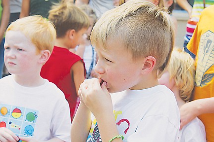 &lt;p&gt;Damien Landrum, who visited the Cherry Festival from Missoula, takes a bite out of his cherry before competing in the cherry pit spitting competition.&lt;/p&gt;