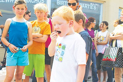 &lt;p&gt;Grady Fields of Washington bites into his cherry to get to the cherry pit during the pit spitting contest on Saturday.&lt;/p&gt;