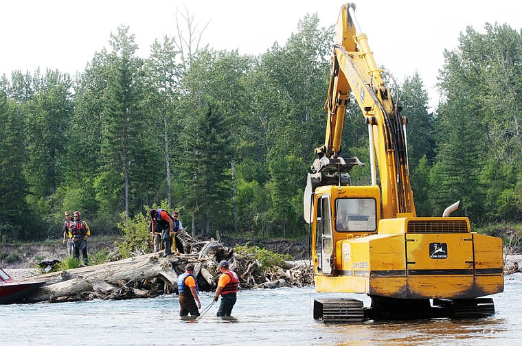 &lt;p&gt;Flathead County Road and Bridge and Flathead County Sheriff&#146;s Department workers attach cables to debris in a logjam Tuesday afternoon in the Flathead River north of the Montana 35 bridge.&lt;/p&gt;