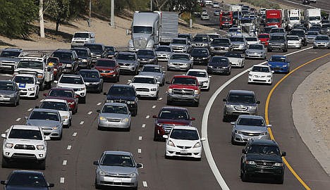 &lt;p&gt;Afternoon rush our traffic moves along a highway in Phoenix on June 24.&lt;/p&gt;