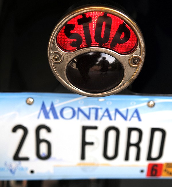 The word &quot;Stop&quot; is illuminated at David Cooley presses the brakes as he parks his 1926 Ford Model on Tuesday in Creston.