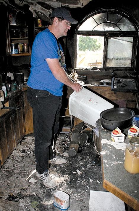 Jason Shueh/Valley Press Keith Baker searches for anything that might be salvageable.