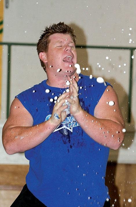 Nick Ianniello/Mineral Independent Kevin Suiter of the Strength Team explodes a soda can with his bare hands during a performance Sunday evening. Suiter used diet soda so that the crowd members in the first few rows who were sprayed by the feat did not have to deal with sticky clothes.