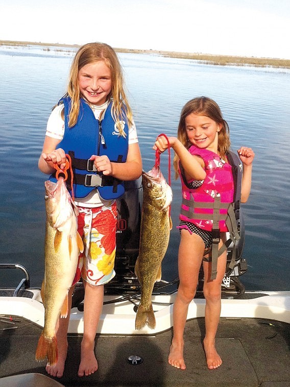 Courtesy photo Raylie and Raegan Wardenaar, both of Royal City,
with two big Walleye.