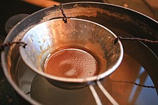 Cahoon uses a stove to make hide glue from hooves, hides and sinew to hold his bows and arrows together.