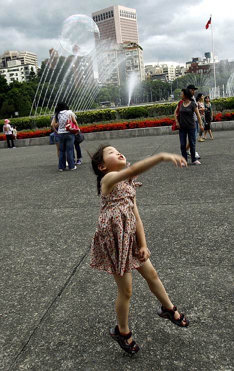 &lt;p&gt;A young mainland Chinese tourist swipes at a bubble at the Sun Yat-sen Memorial Hall in Taipei, Taiwan, on July 20.&lt;/p&gt;