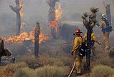 Wildfire jumps aqueduct, approaches homes