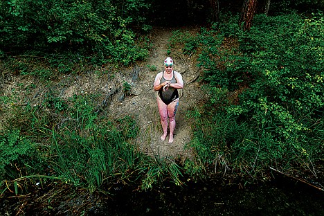 &lt;p&gt;Elaine Howley sets her watch from a steep embankment prior to setting off on a record-setting swim of Lake Pend Oreille.&lt;/p&gt;